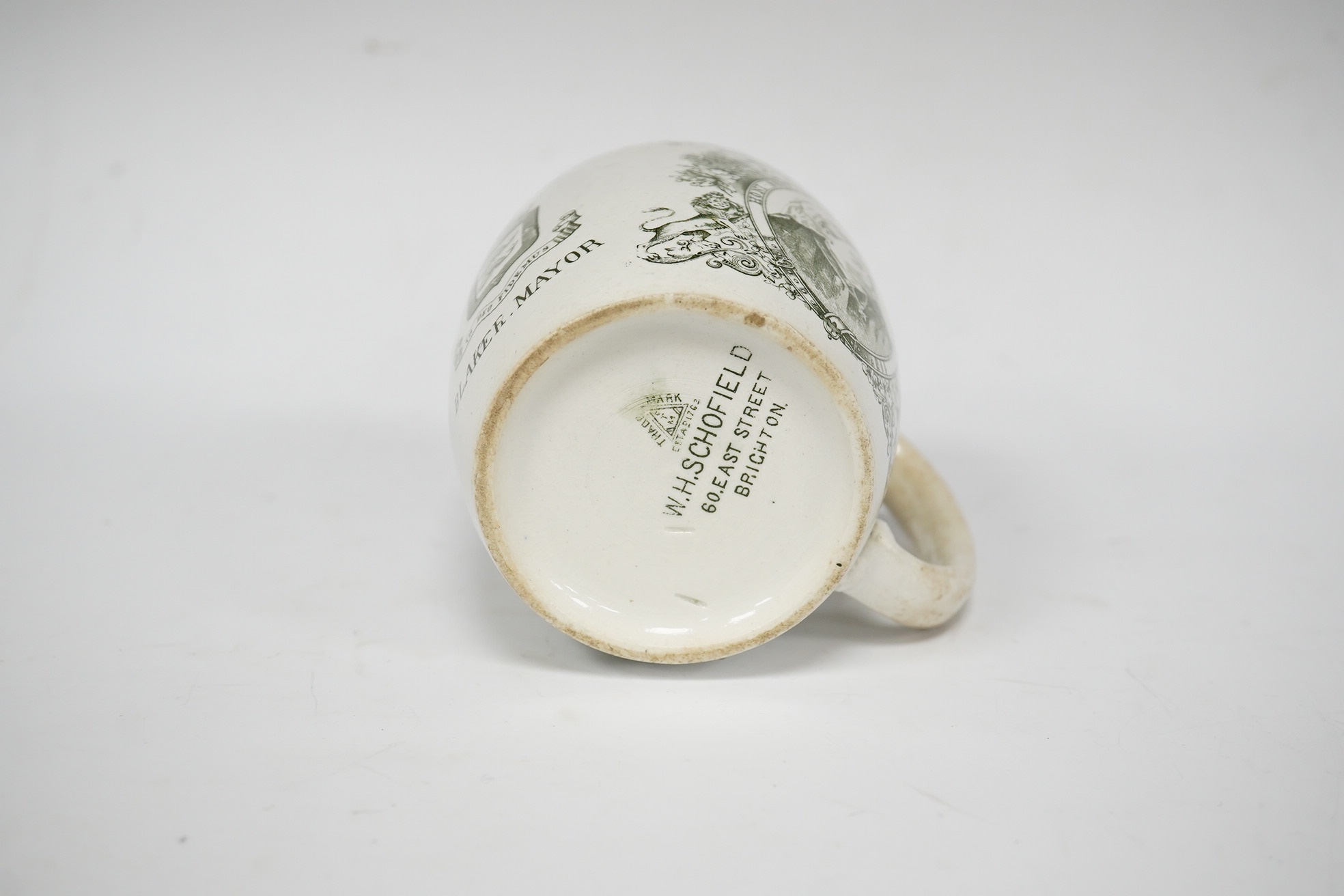 A Queen Victoria commemorative mug celebrating the 1897 Diamond Jubilee, County Borough of Brighton, 10cm high. Condition - poor